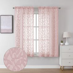 a pink curtain hanging on the side of a window next to a white dresser and lamp