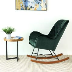 a blue rocking chair next to a table with a potted plant on top of it