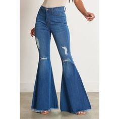 A pair of exaggerated, high-rise flare jeans featuring a front whiskered wash, open distressed knee detail, classic 5-pocket construction, frayed raw hem, and a zip-fly closure. -Rise: 11" Inseam: 33" -Model is 5'8" and wearing a size 3 -True to size Denim Flare Jeans With Frayed Hem For Fall, Trendy Fall Flare Jeans With Frayed Hem, Fall Stretch Flares With Frayed Hem, Distressed Cutoff Flare Jeans For Fall, Non-stretch Denim Flares For Fall, Ripped Mid-rise Flare Jeans For Fall, Casual Flare Pants With Frayed Hem, Casual Distressed Denim Flares, Mid-rise Ripped Flare Jeans For Fall