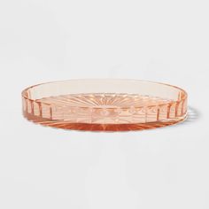 an orange glass bowl on a white background