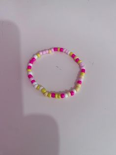 This is a pink lemonade theme bracelet. I made this by myself. Sweet Pink Beaded Bracelets, Fun Pink Beaded Bracelets, Fun Pink Beaded Bracelets With Round Beads, Fun Pink Friendship Bracelets With Colorful Beads, Sweet Pink Beaded Bracelet With Round Beads, Pink Colorful Beads Friendship Bracelets, Pink Playful Bracelets For Friendship, Fun Pink Stretch Bracelet For Friendship, Fun Pink Handmade Friendship Bracelets