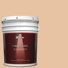 a bucket of marquee paint on a peach colored background with the words behrf marquee