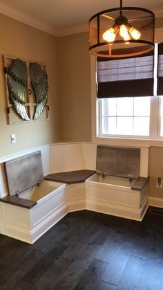 an empty room with wooden flooring and two windows in the corner, one window is closed