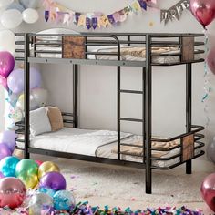 there is a bunk bed in the room with balloons and confetti around it