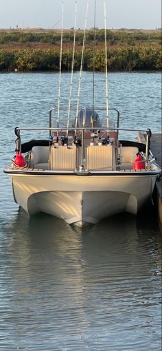 a white boat floating on top of a body of water