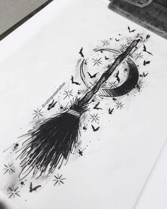 a black and white drawing of a broom with bats flying around it on top of a sheet of paper