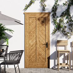 a wooden door sitting on top of a patio next to a chair and table with an umbrella