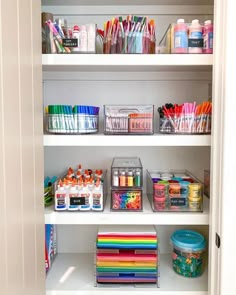 the shelves are filled with markers, pens, and other crafting supplies for kids