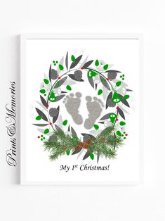 a christmas card with baby's footprints and greenery