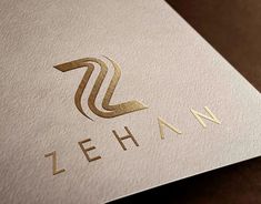 the logo for zehann is shown on a white and gold business card,