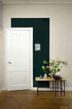 a room with green walls and white doors