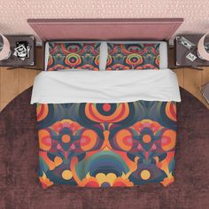 an aerial view of a bed with colorful comforter and pillows