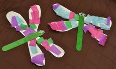 three pieces of paper that have been made to look like dragonflies with green and pink wings