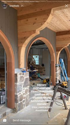 the interior of a building being built with wood and stone arches, windows, and doors