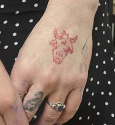 a woman's hand with a tattoo on it