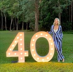 a woman standing in front of a sign that says 40