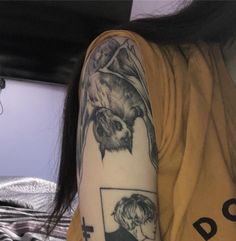 a woman with a tattoo on her arm has a photo of herself and an owl