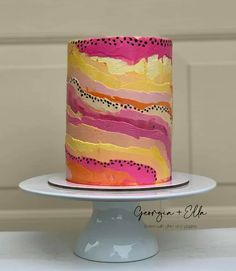 a multi - colored cake with polka dots on it