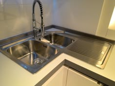 a stainless steel sink and counter in a kitchen