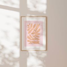 a framed photograph hanging on the wall next to a window with sunlight coming through it