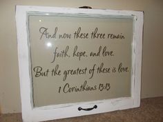 a white framed sign with the words and then these three remain faith hope and love but the greatest of those is love