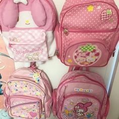 hello kitty backpacks are lined up against the wall