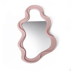 a mirror that is on the wall with a pink frame and curved design around it