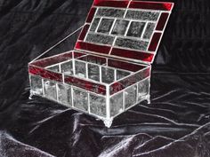 a glass box sitting on top of a black cloth