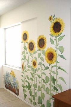 the sunflowers are painted on the wall next to the window in the room