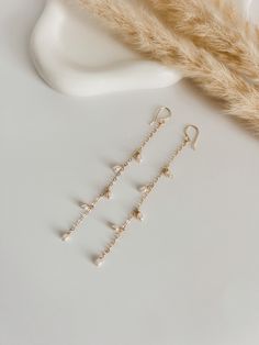 Long, elegant and delicate earrings, carefully handmade with natural rice-type pearls, wire and chain filled with 14K gold. Easy to use, perfect for an elegant style, wedding, or for everyday use. Ideal gift for women. Durable. Length 4 Inch Everyday Gold Wire Wrapped Pearl Earrings, Delicate Everyday Pearl Earrings With Chain, Delicate Pearl Chain Earrings For Everyday, Delicate 14k Gold Filled Earrings With Pearl Chain, Delicate Pearl Chain Earrings In 14k Gold, Dainty Linear Pearl Earrings With Pearl Chain, White 14k Gold Filled Pearl Drop Linear Earrings, 14k Gold Filled White Pearl Drop Linear Earrings, White Pearl Drop Linear Earrings In 14k Gold Filled