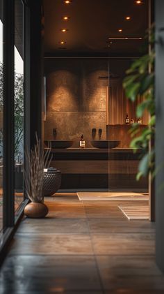 a modern bathroom with large glass doors leading to the outside