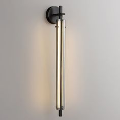 a wall mounted light with two tubes attached to it's side and the lights on both sides