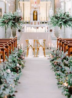 the aisle is decorated with greenery and candles for an elegant wedding ceremony at st mary's church