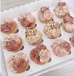 there are many cupcakes with pink frosting and gold decorations on the top