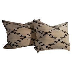 two black and white pillows sitting next to each other