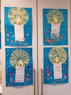 three pieces of paper are taped to the wall and decorated with flowers, leaves, and a candle