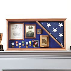 an american flag and medals are on display in a wooden frame with other items around it