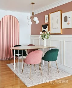 a dining room with pink and green chairs