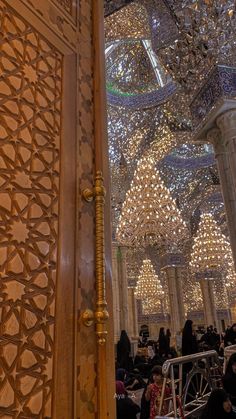 the inside of a building with chandeliers hanging from the ceiling