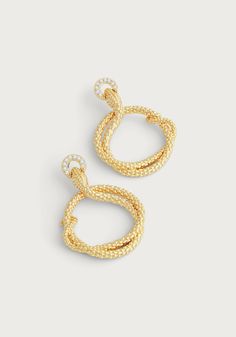 Elevate your style with the luxurious Serpent Holding Ring Hoop Earrings. Crafted from 18K gold dipped brass and adorned with sparkling handset pavé crystals, these earrings exude sophistication and opulence. Indulge in elegance with these stunning earrings. Made from 18K gold dipped brass and encrusted with dazzling handset pavé crystals, these hoops exude luxury and glamour. 18K gold plated brass Crystals 2" L X 1.4" W Luxury Gold Hoop Earrings With Pave Setting, Gold Pave Setting Earrings For Evening, Elegant Gold Hoop Earrings With Pave Setting, Evening Gold Earrings With Pave Setting, Luxury Hoop Earrings, Glamorous Gold Plated Yellow Gold Hoop Earrings, Gold Diamond Hoop Earrings For Evening, Gold Cubic Zirconia Hoop Earrings For Evening, Queen Victoria Engagement Ring