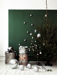 a christmas tree and other decorations in front of a green wall