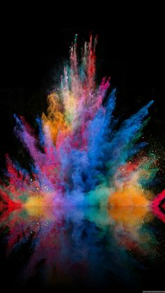 colorful powder exploding in the air on a black background