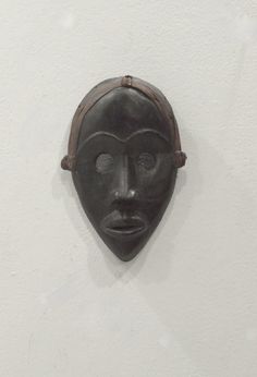 a black mask hanging on the wall