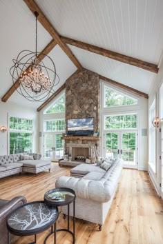 a living room filled with lots of furniture and a fire place in the middle of it