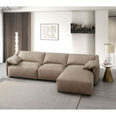 a living room scene with focus on the sofa and pillows in the corner, while the rug is also beige