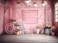 a room with pink walls and flowers in buckets on the floor next to a ladder