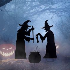 two silhouettes of witches in the woods with jack - o'- lanternes