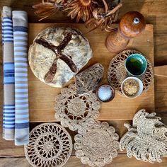 various crocheted doily and other items laid out on a wooden table top