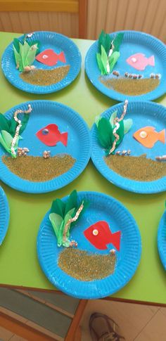 paper plates with fish and plants on them