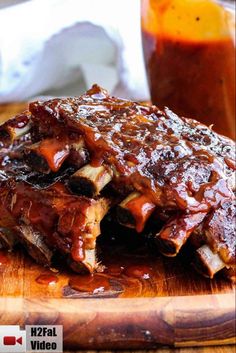 ribs covered in bbq sauce on a cutting board